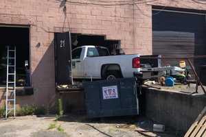 Pickup Truck Crashes Into Building In Holtsville, Injuring Two Employees