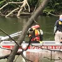 <p>Elmwood Park firefighters return body (unseen in photo) to the shore.</p>