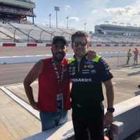 <p>NASCAR crew member Ryan Flores, right, with Marzano.</p>