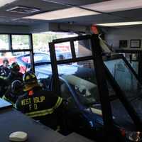 <p>Firefighters work to remove the occupants from the car.</p>