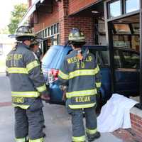 <p>Firefighters access the situation.</p>