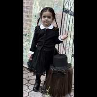 <p>Wednesday Addams and her trick-or-treat bucket.</p>