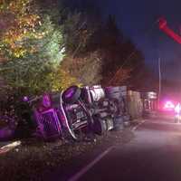 <p>Tractor-trailer transporting liquid eggs rolled over, spilling the contents on the side of the road.</p>