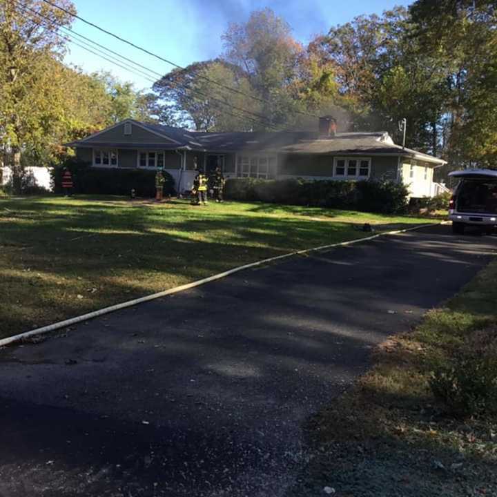 Firefighters were able to save a dog who was hiding when smoke began to fill a home.