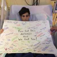 <p>Friends keep Antonio&#x27;s spirits up with a sign.</p>