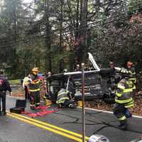 <p>Tallman Volunteer firefighters work to remove the trapped driver.</p>