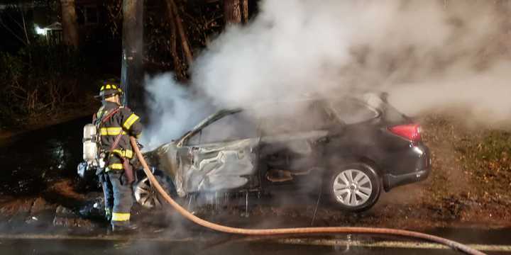 A car burst into flames after the driver lost control and struck a utility pole.