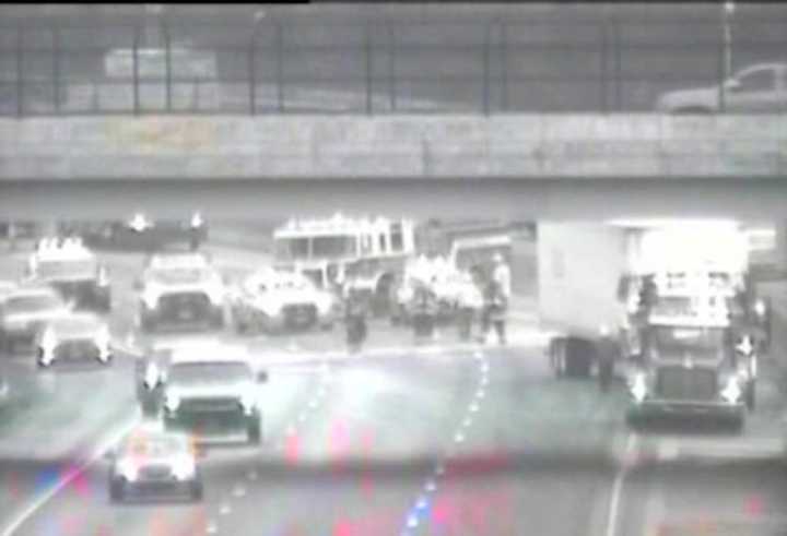 Crews clean up the scene of a jackknifed tractor-trailer on I-95 southbound between Exits 4 and 3 on Monday morning in Greenwich.