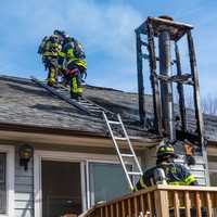 <p>Firefighters check-out the damage.</p>