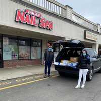 <p>Tiffany and Lucas from Dolan Nail Spa loading up the supplies to donate.</p>