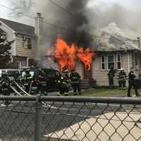 <p>East Rockaway firefighters attack the flames.</p>