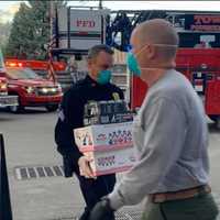 <p>First responders unload a supply of &#x27;goodies&#x27; for employees working at two hospitals.</p>