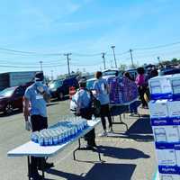 <p>Hundreds of cars lined up to receive food during an event sponsored by the Connecticut Food Bank.</p>