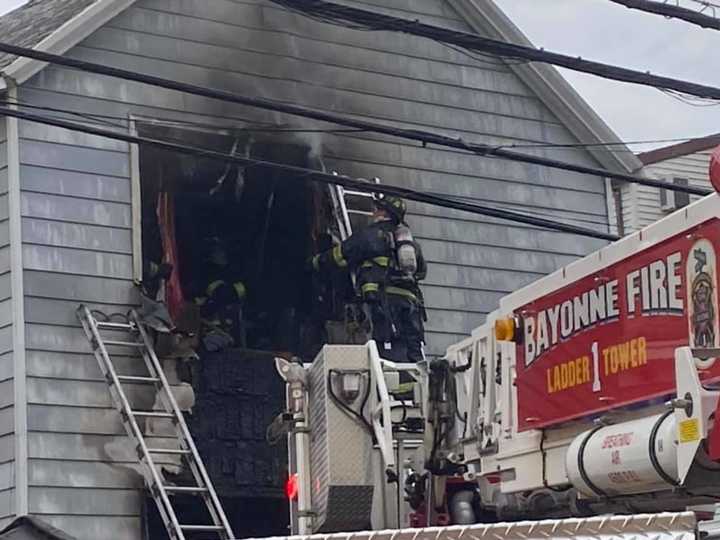 Bayonne firefighters rescue residents from the second floor of the E. 16th Street house.