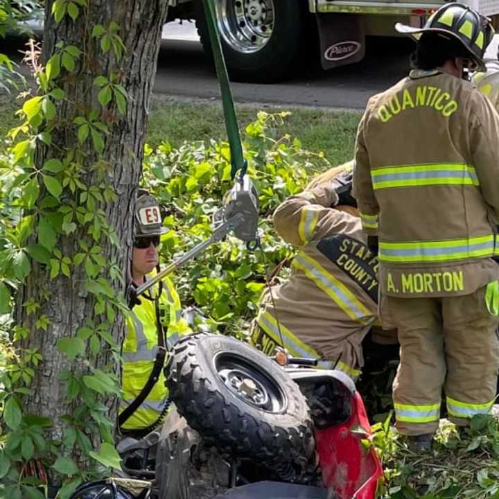 Firefighters in Stafford County lift an ATV out of a ravine after it crashed on Monday, May 30, in Woodbridge. The driver suffered serious but not-life-threatening injuries in the wreck.