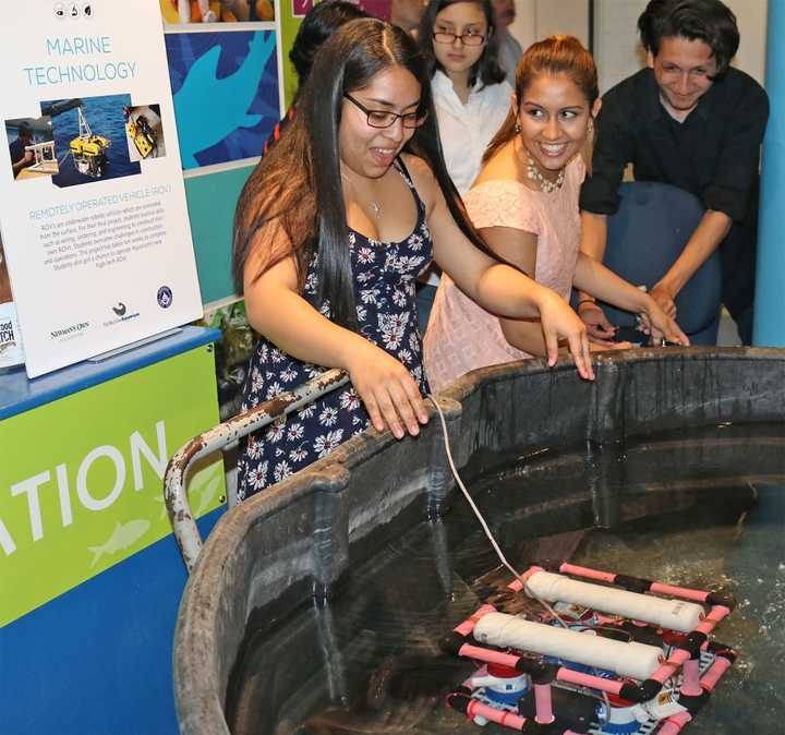 Visitors play at one of the exhibits at The Maritime Aquarium in Norwalk. The aquarium, which draws about 500,000 visitors a year, has just received a large grant to educate the public about climate change and other pressing environmental issues.