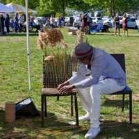 <p>Karl Scott adorns a chair with wild grasses at last year&#x27;s Art in the Park in Piermont.</p>