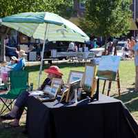 <p>Art lovers roam around the 2015 Art in the Park in downtown Piermont.</p>