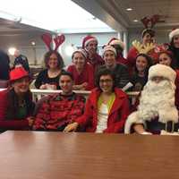 <p>David Boone with his elves and last year&#x27;s Santa Boone recipient, Bearn Vargas, and her son.</p>