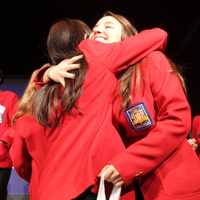 <p>Regina Yoo receives a hug from SkillsUSA state officer and fellow Bergen County Academies student Hana Friedman</p>