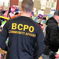 <p>Local and county officers teamed up to collect and deliver the presents.</p>