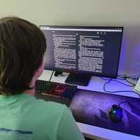 <p>A Southern Westchester BOCES high school student reads from a desktop computer.</p>