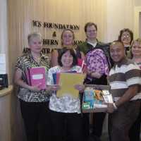 <p>Volunteers help to collect and pack school supplies for children in need.</p>