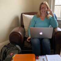 <p>New Canaan High School Nurse Betsy Imbrogno talks on the phone to a New Canaan resident.</p>