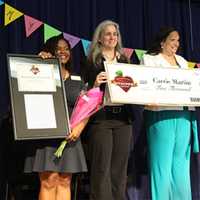 <p>Carrie Martin, second from right, is presented with a check by Barnes &amp; Noble officials after being named National Teacher of the Year for 2015-2016. Martin teaches second grade at the Evers Park Elementary School in Denton, Texas,  .</p>