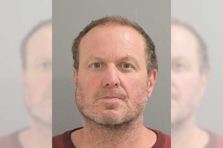 Richard Bauman, aged 53, was arrested for harassing and assaulting a trio based on their national origin, police said.