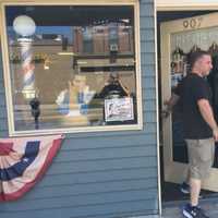 <p>Newly shorn, one of Mark Sinnis&#x27; last customers leaves the Beale Street Barber Shop in Peekskill Wednesday.</p>