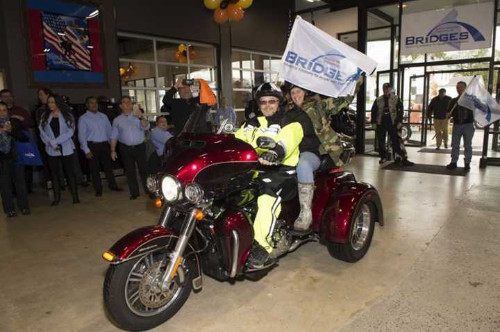 A motorcade brought in the flag with the new logo for B.R.i.D.G.E.S., formerly Rockland Independent Living Center, to kick off the Roll It Out event on Oct. 22 at Harley-Davidson in Nanuet.