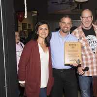 <p>Madison Orlando, left, Tom Orlando, second from right, both of Hudson Valley Harley-Davidson and employee Sergio Graziano, far right, present Dr. David Jacobsen, B.R.i.D.G.E.S. executive director, with a plaque.</p>