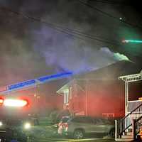 <p>Melrose firefighters battle a house fire on Brunswick Park in the wee hours of Monday, Dec. 11.</p>