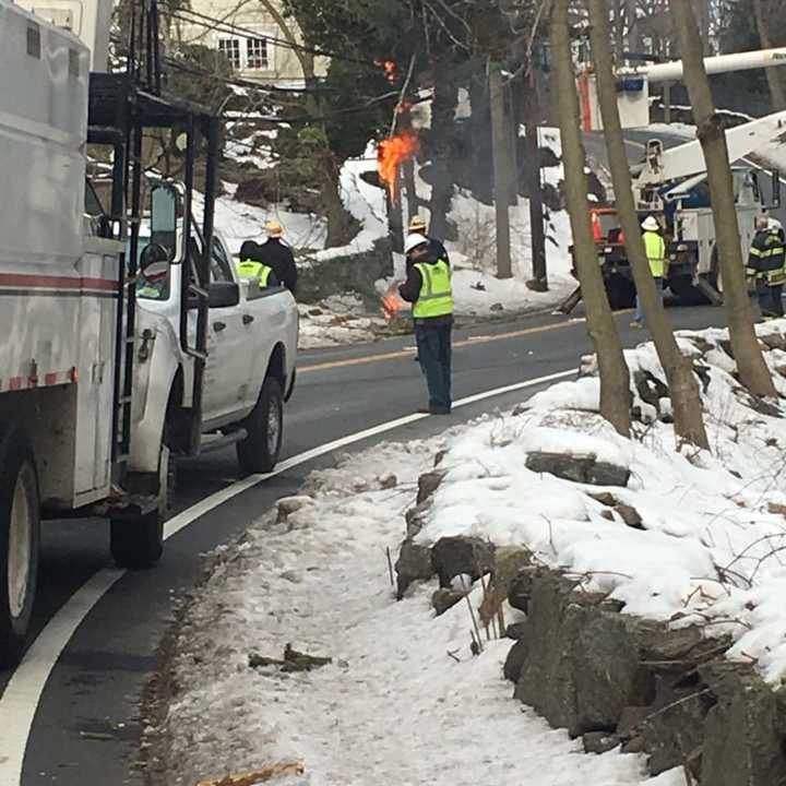 Glenville Road in Greenwich is closed late Tuesday morning with wires down and burning.