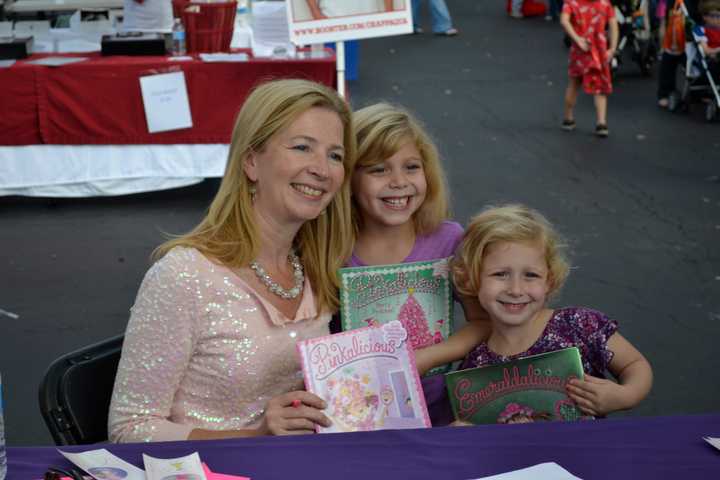 Victoria Khan signs copies of &quot;Pinkalicious&quot; for fans. 