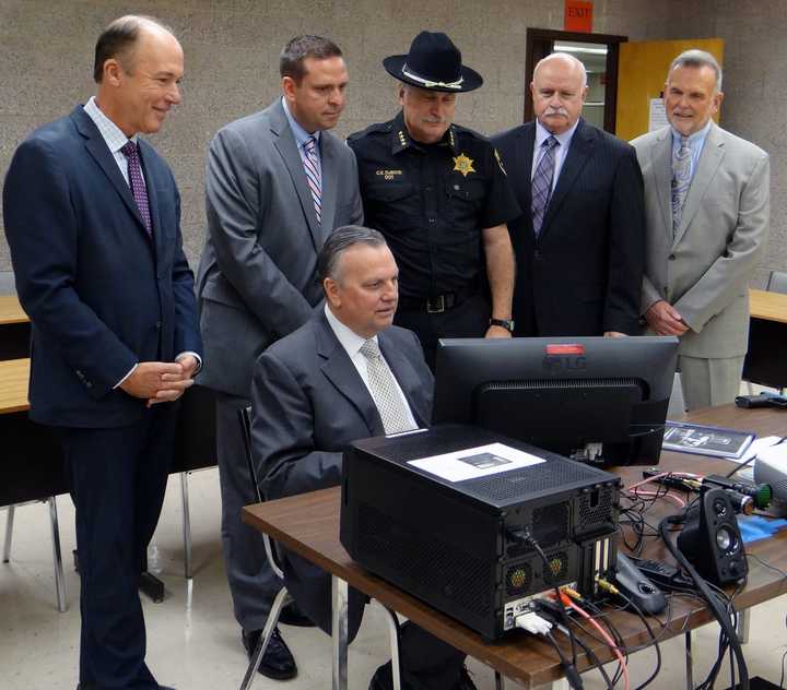 SUNY Orange Criminal Justice Professor Robert Cacciatore (seated), demonstrates the College’s new Response to Resistance Simulator.