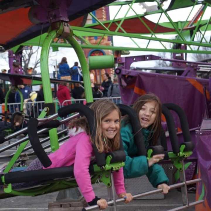 Two thrill seekers prepare to scream at the McKinley School Carnival.