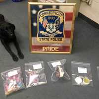 <p>State Police K-9 officer Favor with the drugs seized in a bust during a motor vehicle stop on I-84 in Danbury.</p>