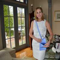 <p>Cathy Zahn of Franklin Lakes poses with one of her bags.</p>