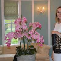 <p>Cathy Zahn of Franklin Lakes shows off models one of her bags.</p>