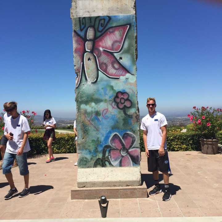 Charles Binder poses with a piece of the Berlin Wall at the Reagan Presidential Library in Simi Valley, California.