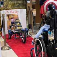 <p>Benjamin Brunson gets his first look at his Batman-theme accessibility tricycle, easily the best Batmobile ever constructed. The second grader is a big fan of the Caped Crusader.</p>