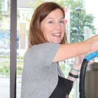 <p>Andrea V. Collins at a milk chocolate tempering machine </p>