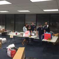 <p>Members of the Clarkstown Police Department Explorers program wrapped gifts donated for local families on Friday night.</p>