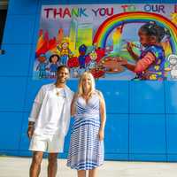 <p>Victor Cruz, former New York Giants wide receiver, and MetLife mural contest-winning artist Tricia Reilly-Matthews</p>