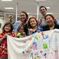 <p>Guests at Anatole&#x27;s wish celebration signed a beach towel to use during her upcoming trip.</p>