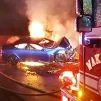 <p>A Tesla electric vehicle burns on Interstate 95 in Wakefield Thursday night following a single-vehicle crash.</p>