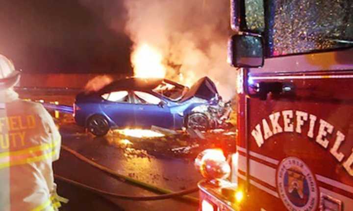 A Tesla electric vehicle burns on Interstate 95 in Wakefield Thursday night following a single-vehicle crash.