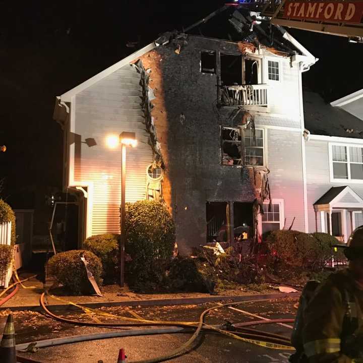 A three-alarm fire heavily damages a condo at 1 Southfield Ave. in Stamford on Wednesday evening.